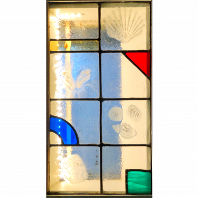 This was a commission for a window in a tiny cottage in Hastings Old Town. It hides an ugly window glazed with wired glass. I created the shell images by slumping glass over beach shells.